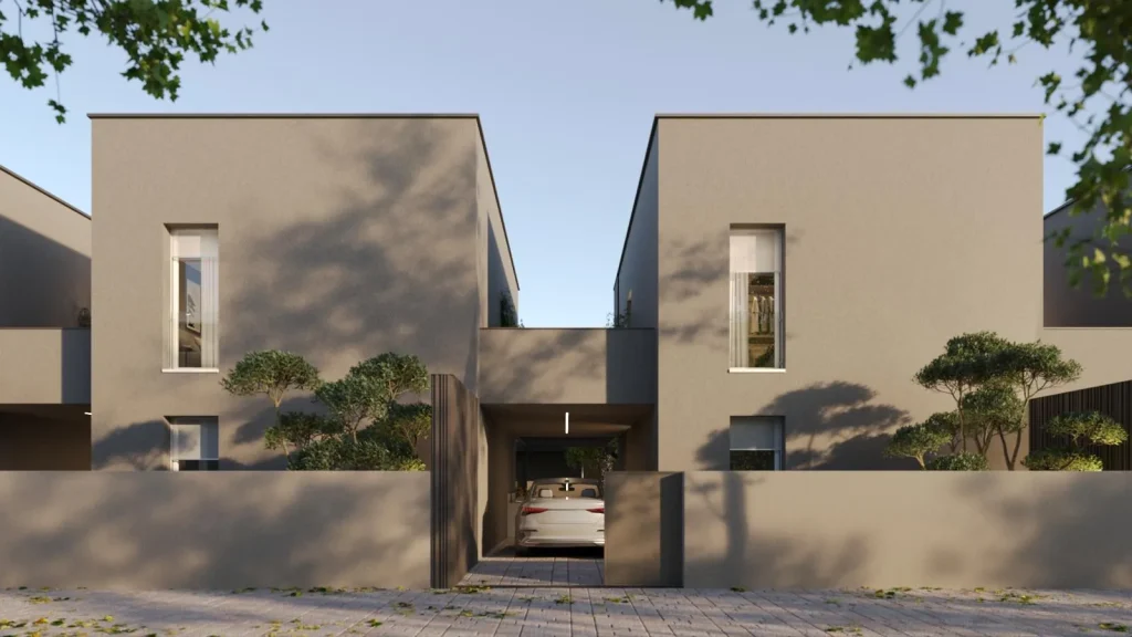 Facciata d'ingresso di Residenze Corte Verde con volumi squadrati color tortora e ingresso carraio